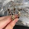 Chanel Metal Lambskin Quilted CC Turnlock Chain Hoop Earrings Gold Black