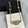 Chanel Necklace – Metal, glass pearls & strass, gold, pearly white & multicolor