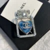 Chanel perfume brooch