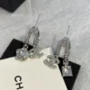 CHANEL silver perfume bottle earrings