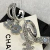 CHANEL silver perfume bottle earrings