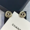 CHANEL golden logo studs