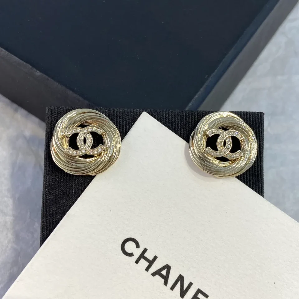 CHANEL golden logo studs
