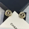 CHANEL golden logo studs
