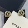 CHANEL golden logo studs
