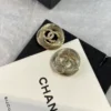 CHANEL golden logo studs