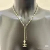 Chanel black and white four-leaf clover enamel necklace