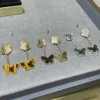 Lucky Alhambra earrings, 2 motifs 18K yellow gold, Mother-of-pearl, Tiger Eye