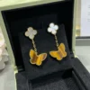 Lucky Alhambra earrings, 2 motifs 18K yellow gold, Mother-of-pearl, Tiger Eye