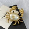 CHANEL Coco Beach 2026 collection  brooch   Metal & Glass  Gold, Pearly White & Black