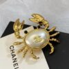 CHANEL Coco Beach 2026 collection  brooch   Metal & Glass  Gold, Pearly White & Black